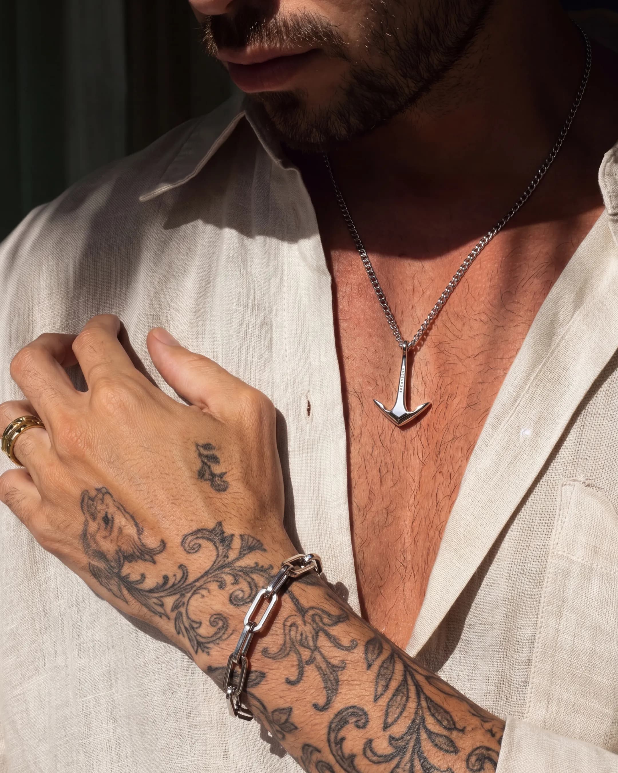 Close-up of silver anchor pendant on a man's chest — AI jewelry product photography for ecommerce